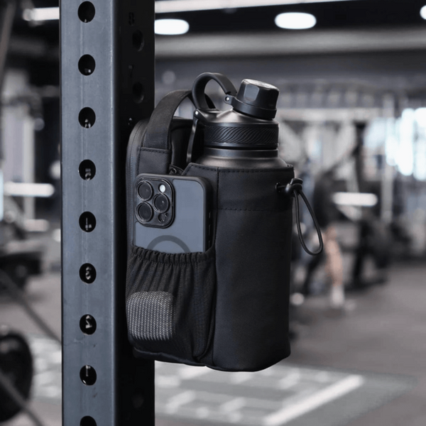 Black water bottle holder with phone pocket attached to a gym rack